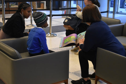 Jill reading to a kid at RMH-NY