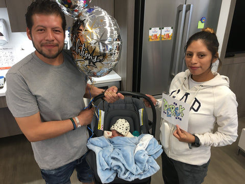 a family at Elmhurst Hospital enjoys the Ronald McDonald Family Room with their baby just released from the NICU