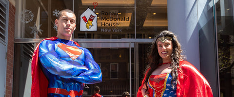 Superman poses next to Wonderwoman for a photo, just outside of the Ronald McDonald House New York.