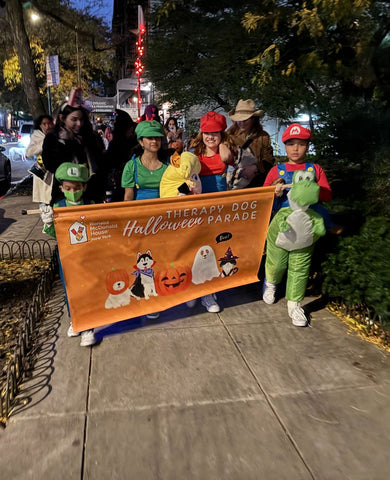 Little SuperMario Brothers hold the RMH-NY banner as the Halloween puppy parade began