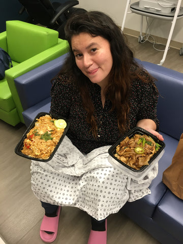 A friend poses with food from the Ronald McDonald family Room ready to eat.