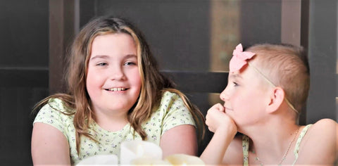 Piper smiles at her funny sister in the RMH-NY wellness center