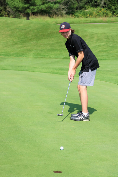 Boy Junior Golfer Putting