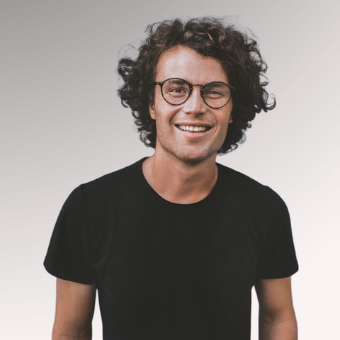 Gentleman dressed in a black tee shirt with longer hair demonstrating a curly hair type for men