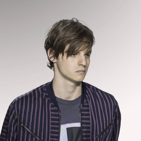 Man with medium-length hair with a fine hair texture demonstrating a styled fringe hairstyle