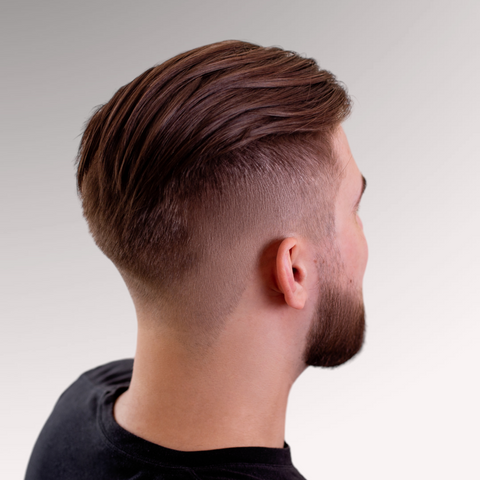 Dark haired man viewed from the back demonstrating a medium-length mid fade hairstyle that is low maintenance for men