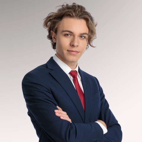 Man dressed in a blue suit with medium length hair demonstrating a low maintenance unkempt hairstyle for men