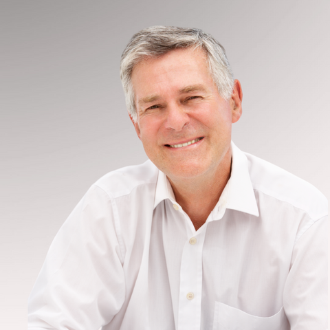 Mature gentleman in a white shirt with gray hair demonstrating a relaxed tapered comb-over for older men who have thinning hair