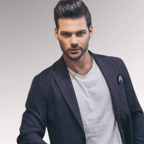 Man in a blue blazer and tee shirt demonstrating a pompadour hairstyle for men who have thinning hair that is coarse