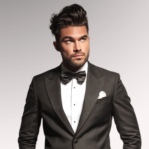 Gentleman in a tuxedo demonstrating a messy pompadour men's hairstyle