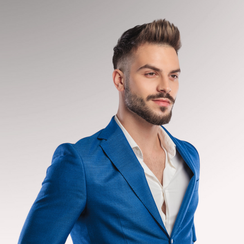 Man in a blue suit with slight facial hair demonstrating a quiff professional men's hairstyle