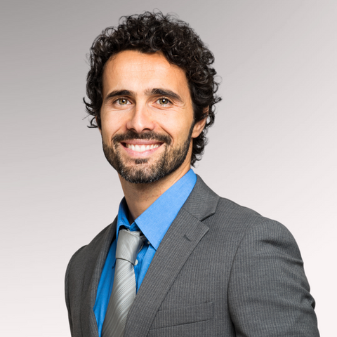 Man in a suit with curly hair demonstrating a longer natural curls professional men's haircut