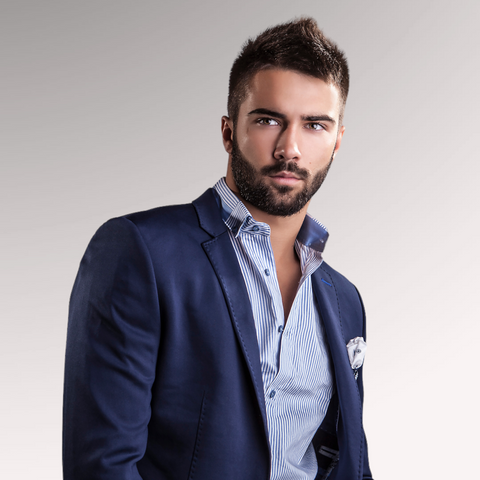 Man in a blue suit with slight facial hair demonstrating a faux hawk professional men's hairstyle