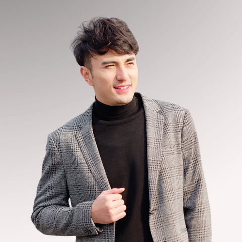 Man dressed in business attire demonstrating a fringe hairstyle for professional men's haircuts