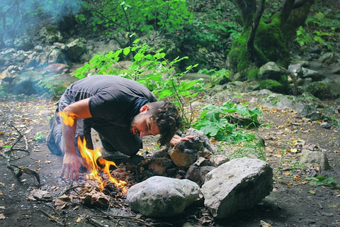 This man has the perfect fire technique to ignite his woods for camp fire