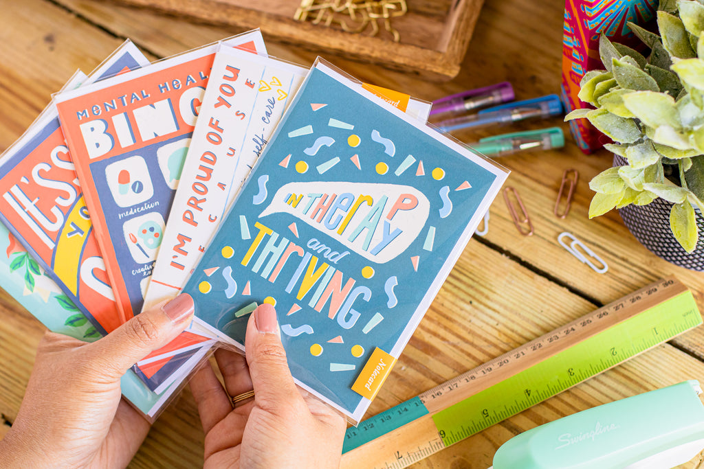 Mental health greeting cards by Curated Dry Goods pictured on a wooden desk