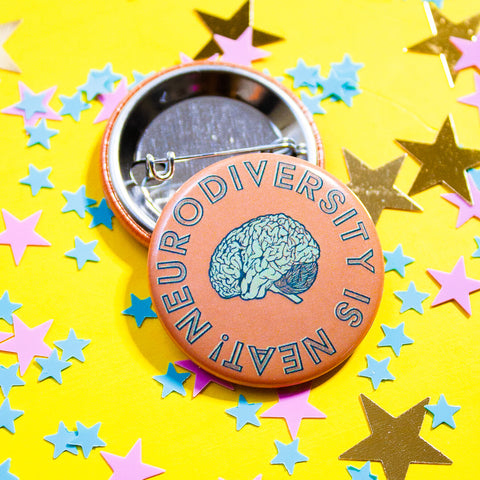 Neurodiversity is Neat Pin by Curated Dry Goods for Mental Health Association of Central Florida, pictured on a yellow background