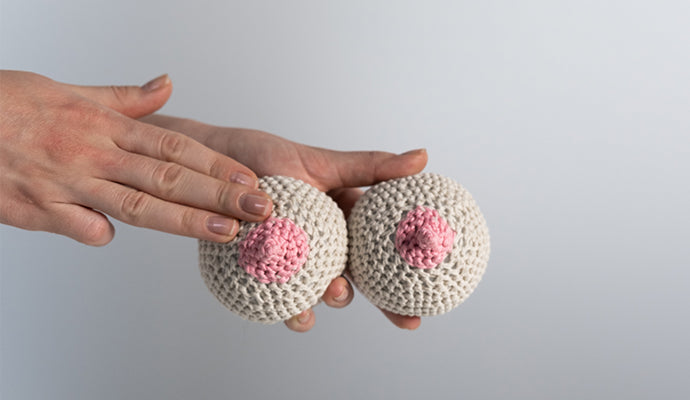 Example of how to give yourself a breast cancer exam using crocheted breasts.