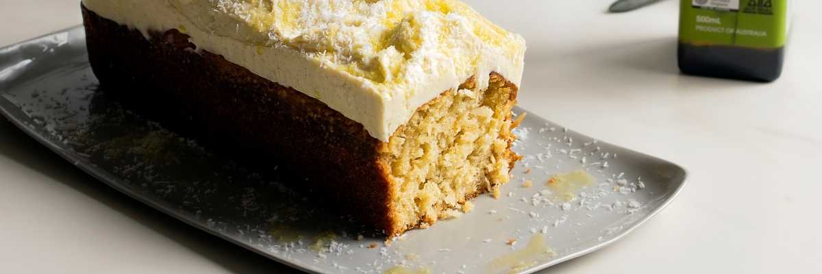 Coconut Olive Oil Cake with Thick Cream Cheese Frosting on a plate