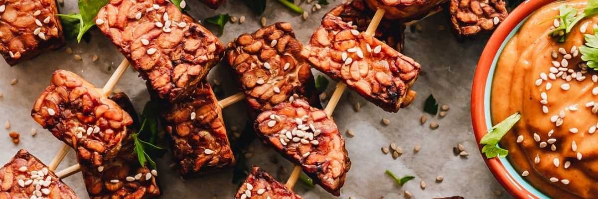 BBQ tempeh cubes on skewers with satay sauce