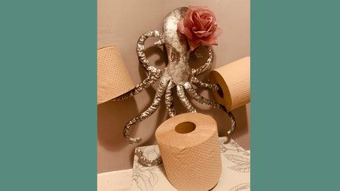 A wall mounted octopus toilet roll holder