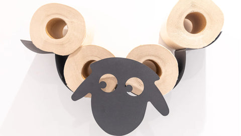 a toilet roll holder in the shape of a sheep