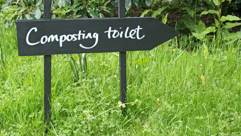 A sign pointing the way to a composting toilet