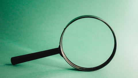 a magnifying glass on a green background