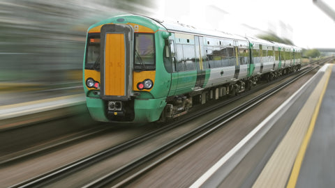 An image of a modern train moving quickly through a station