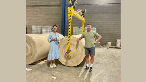 Naked Sprout founders Leila and Tom standing next to a parent roll