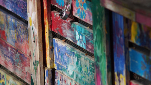 A compost bin painted with bright colours