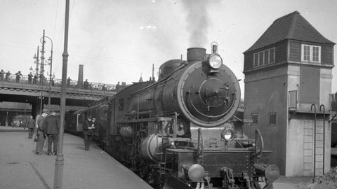 A black and white historical photograph of a steam engine