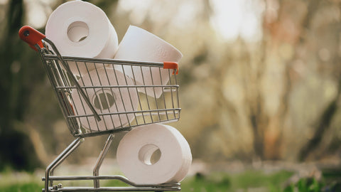 A small trolley filled with toilet rolls