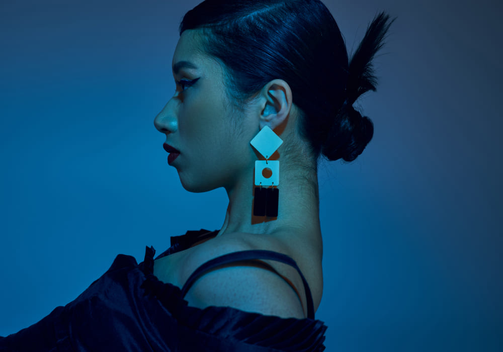 woman wearing bold wooden geometric earrings