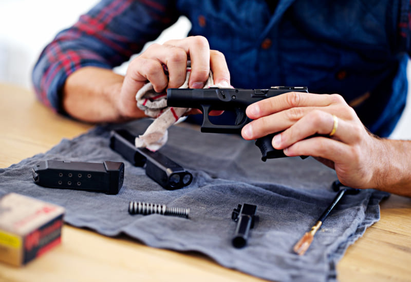 man unloading gun practicing gun safety