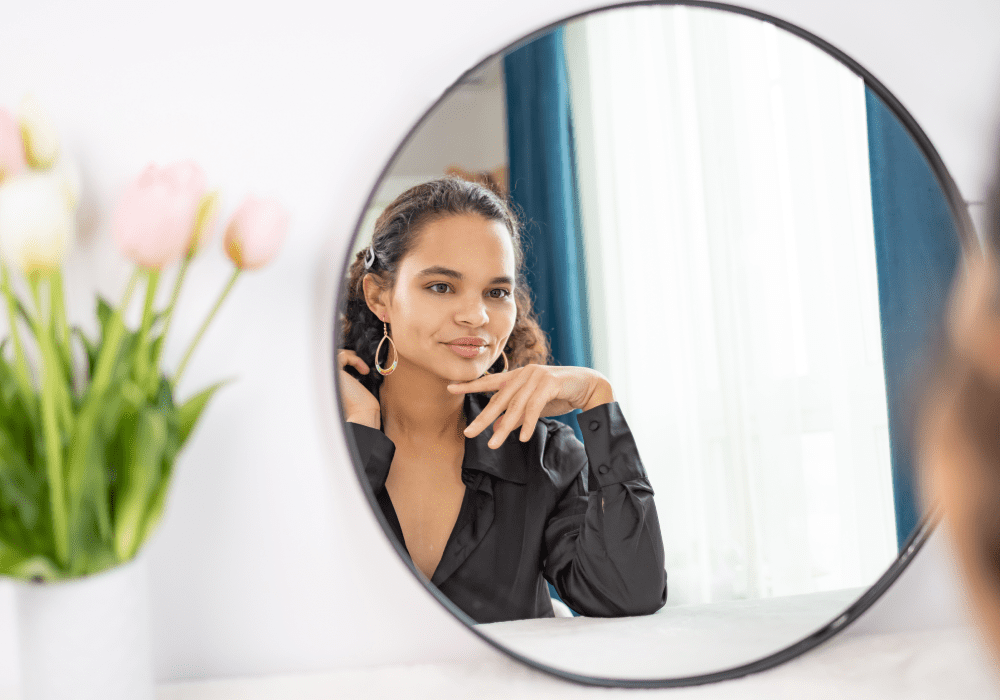 woman staring into mirror thinking about laser engraving