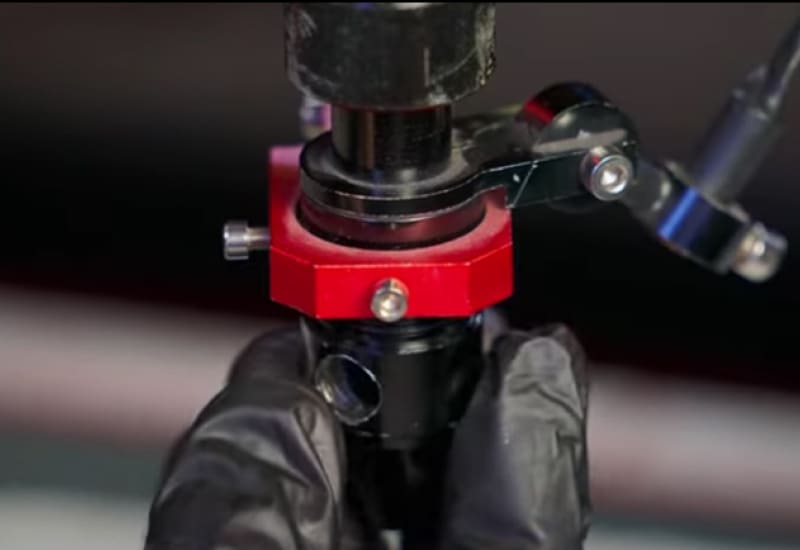 screwing laser nozzle onto laser engraving machine