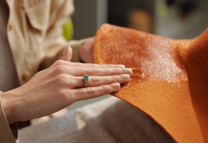 Rubbing cleaning solution onto leather material