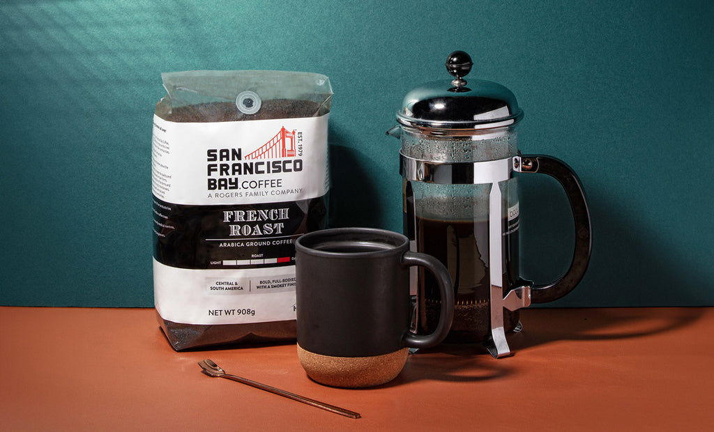 French Roast coffee beans and french press.