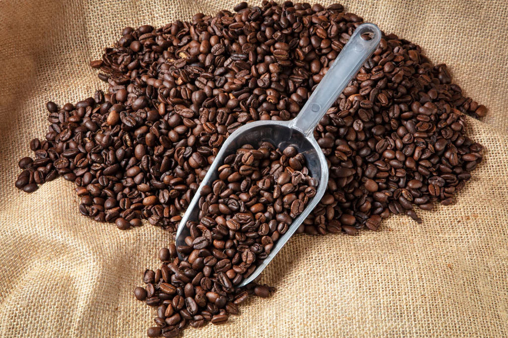 Whole coffee beans with scoop.