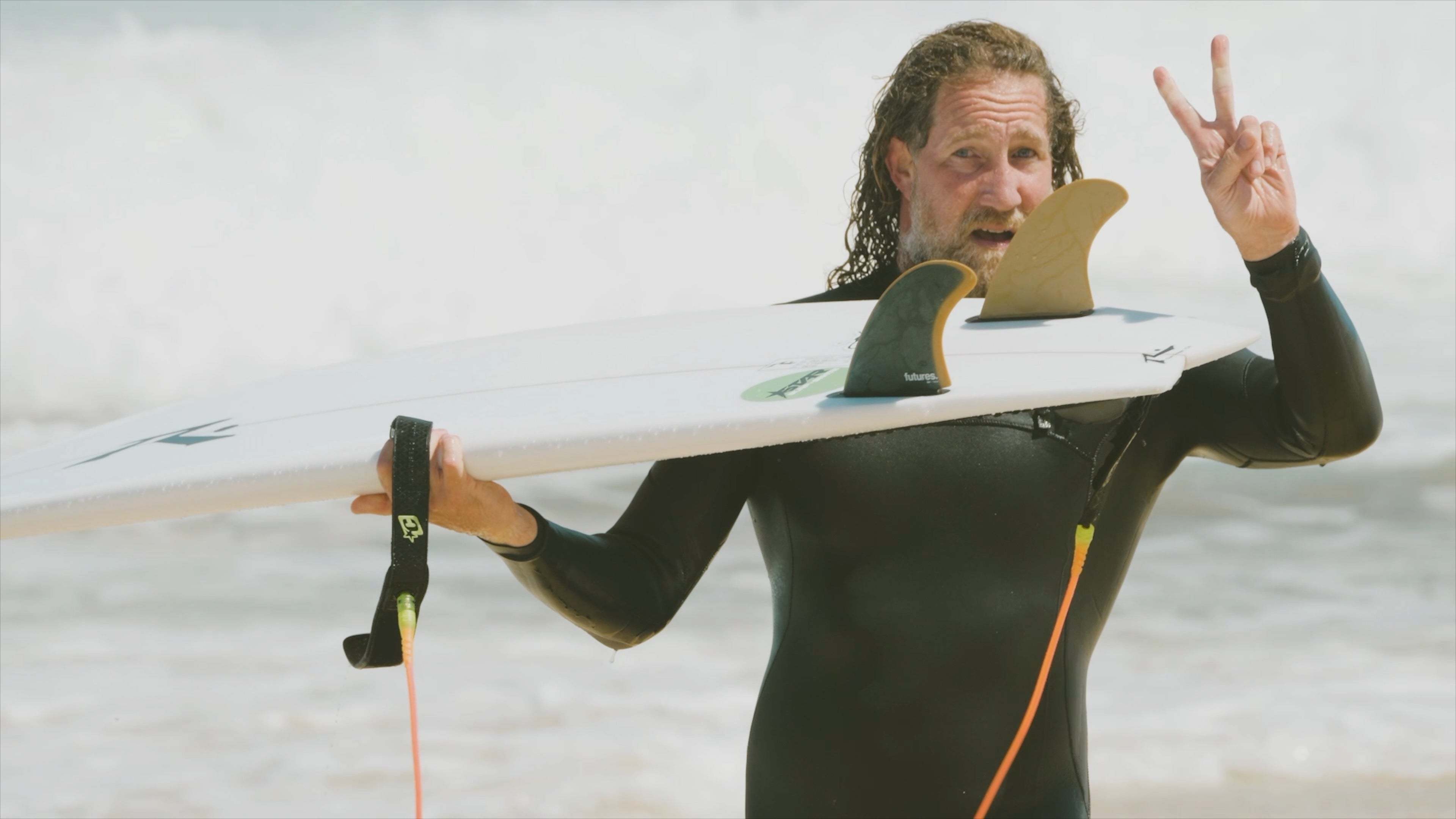 Wooly Macpherson holding The Deuce Twin Fin Surfboard