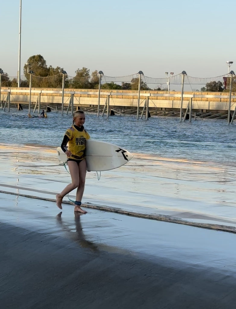 Surfer girl with board