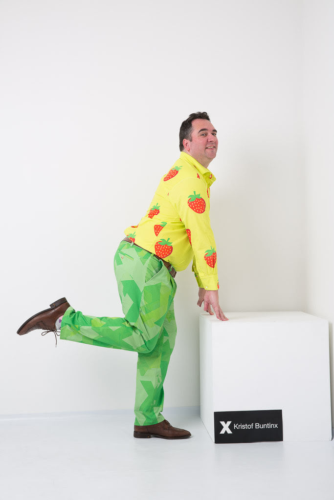 Kristof Buntinx wearing a strawberry shirt and green trousers 
