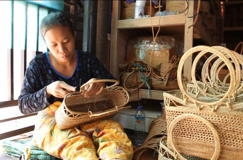 Authentic Bali rattan bags sold by Ganapati Crafts Co. are being woven by an Indonesian woman in Bali