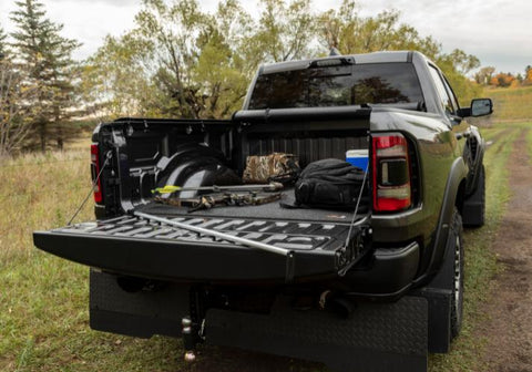 Access Original roll-up tonneau cover in the open position with hunting gear in the back of a Ram 1500.