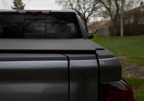 Lomax stance hard folding tonneau cover in the closed position on a GMC Sierra.