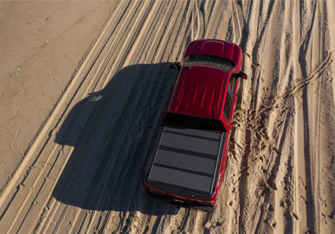 BAKFlip MX4 on a red Chevy Silverado driving through the sand.