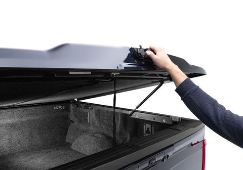 UnderCover Elite LX painted tonneau cover is being opened.