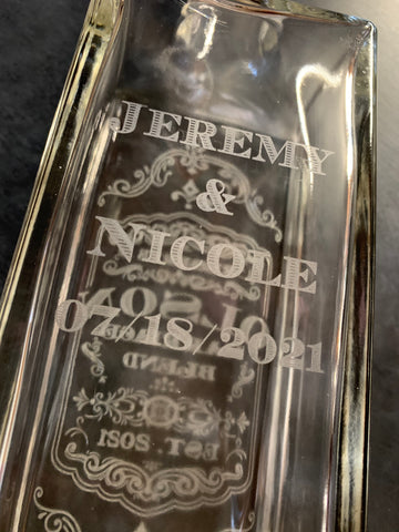 A couple's name custom etched on the back of a decanter for the perfect wedding gift