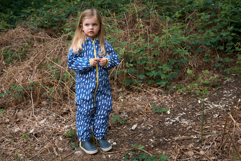 Girl wearing muddy puddles lightning puddlesuit